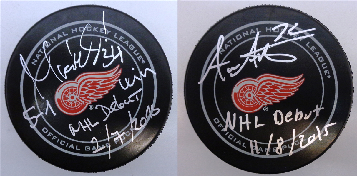 Athanasiou and Mrazek Autographed Game Pucks w/ NHL Debut Inscriptions